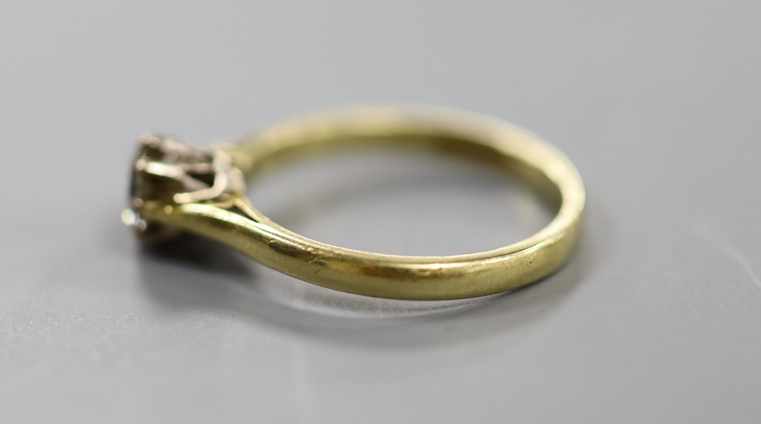 A modern 18ct gold and solitaire diamond ring